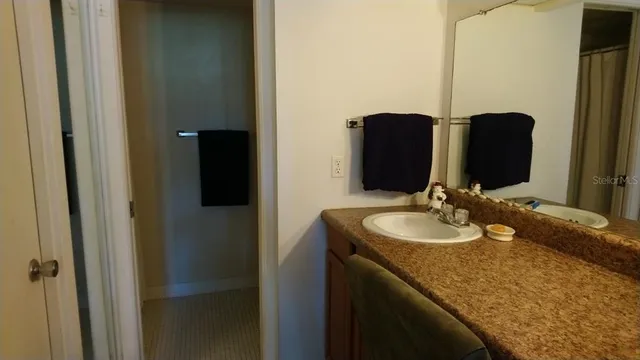 a bathroom with double vanity and a mirror