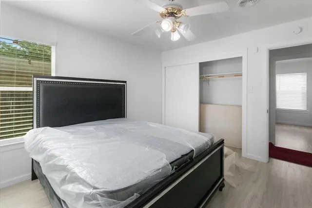 a bedroom with a bed and a chandelier