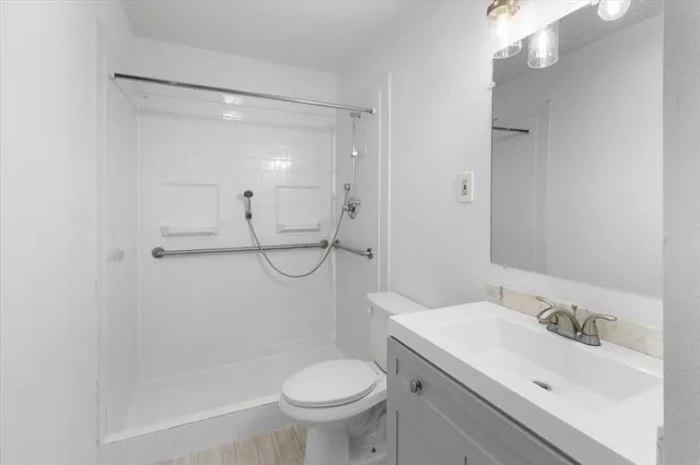 a bathroom with a sink toilet and shower