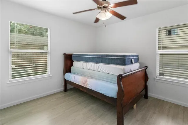 a bedroom with a bed and a window