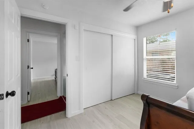 a view of a room with wooden floor and windows