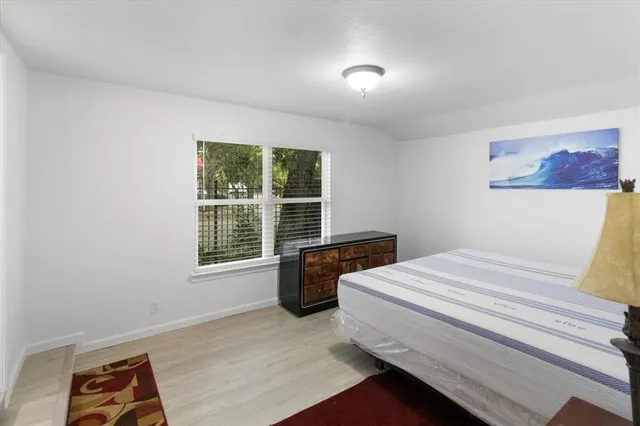 a bed room with a bed and a window