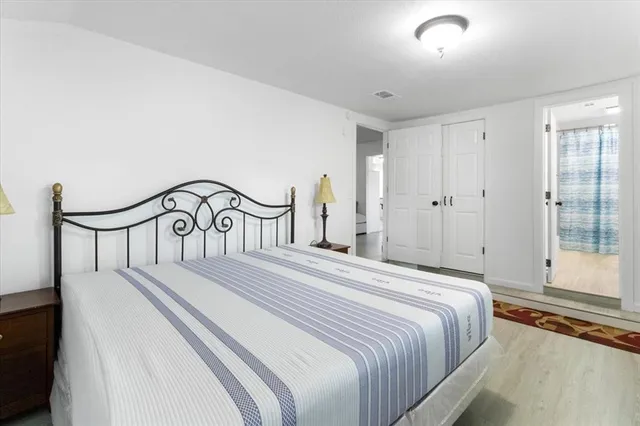 a bedroom with a large bed and a large window