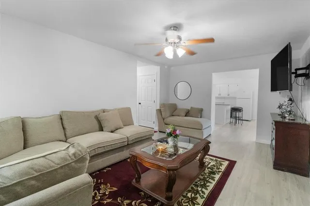 a living room with furniture and a chandelier