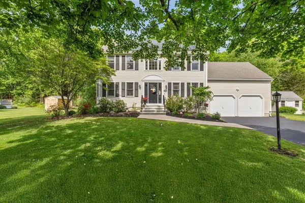 a front view of house with yard and green space