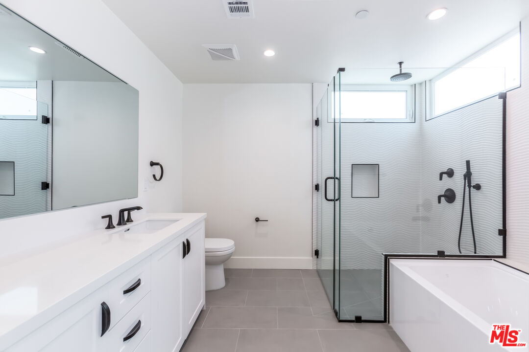857 North Hayworth Avenue, Unit 403 Los Angeles, CA 90046 - Photo 13 of 52 a bathroom with a tub sink shower and mirror