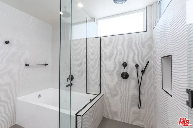 a bathroom with a tub and a shower