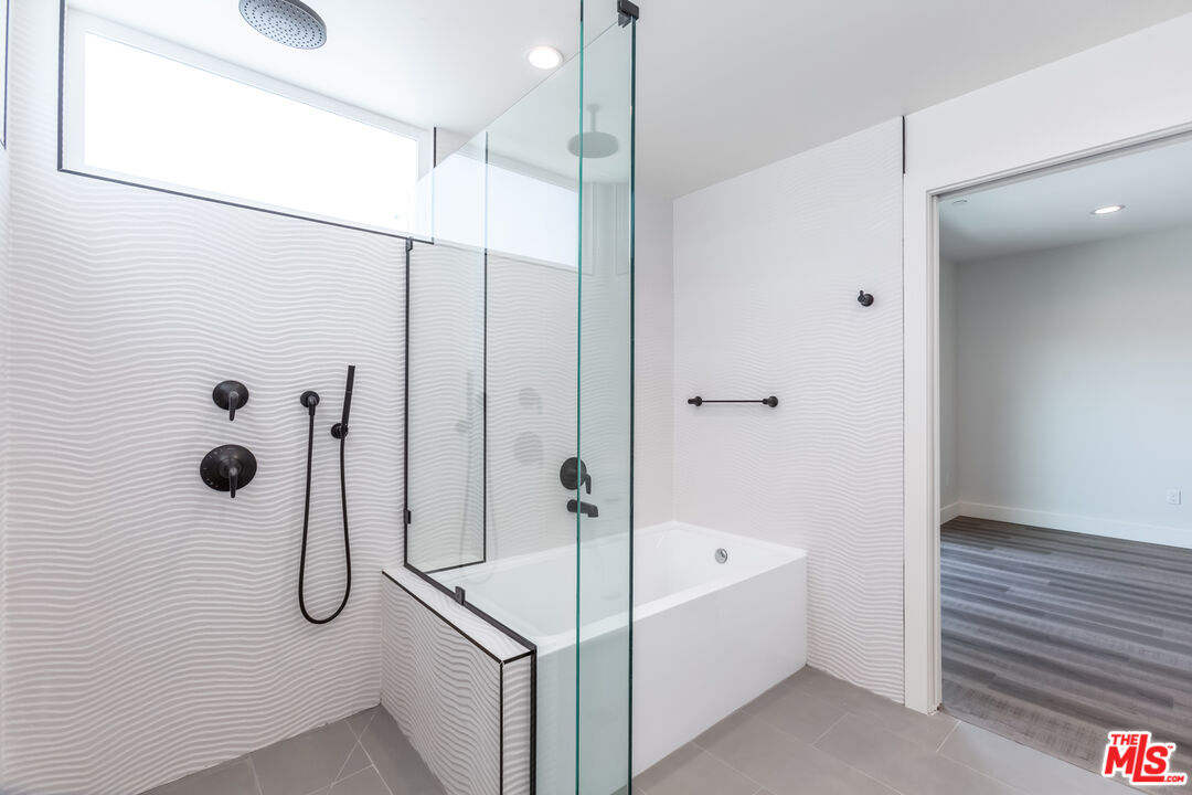857 North Hayworth Avenue, Unit 403 Los Angeles, CA 90046 - Photo 15 of 52 a bathroom with a bath tub and shower