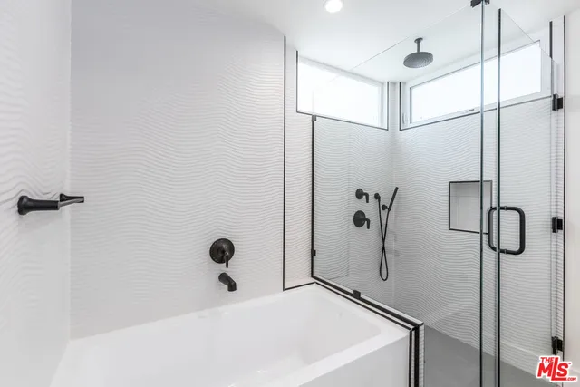 a bathroom with a bathtub and shower