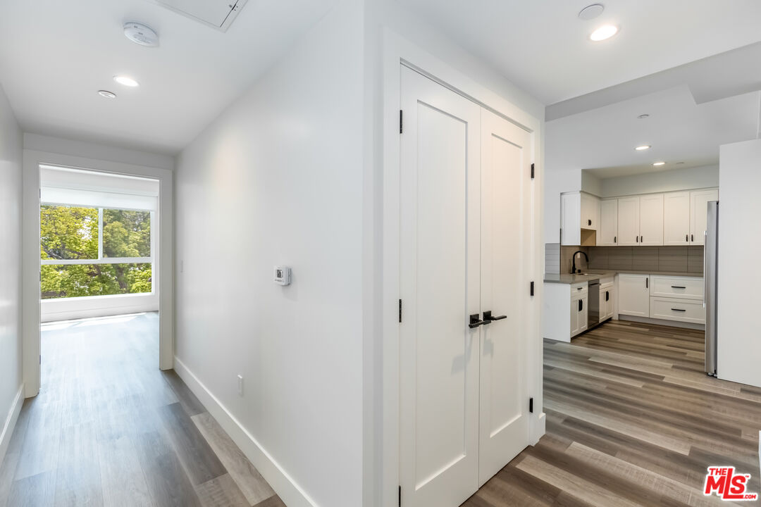 857 North Hayworth Avenue, Unit 403 Los Angeles, CA 90046 - Photo 22 of 52 a view of a hallway with wooden floor and staircase