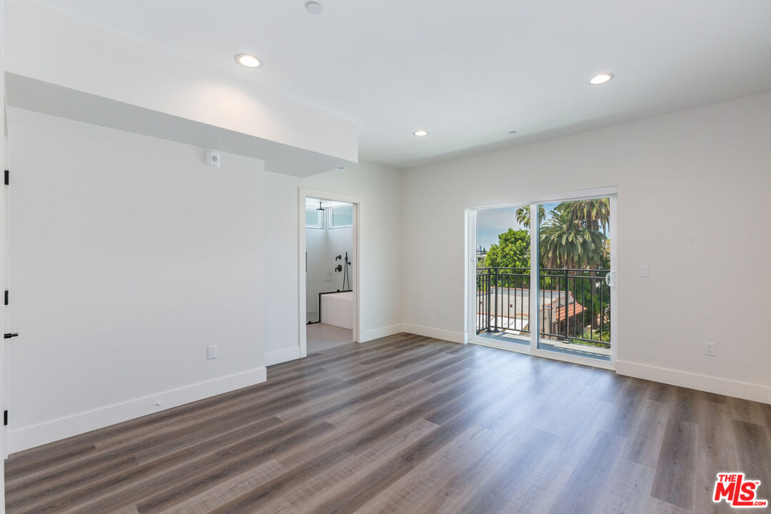 857 North Hayworth Avenue, Unit 403 Los Angeles, CA 90046 - Photo 26 of 52 wooden floor in an empty room with a window