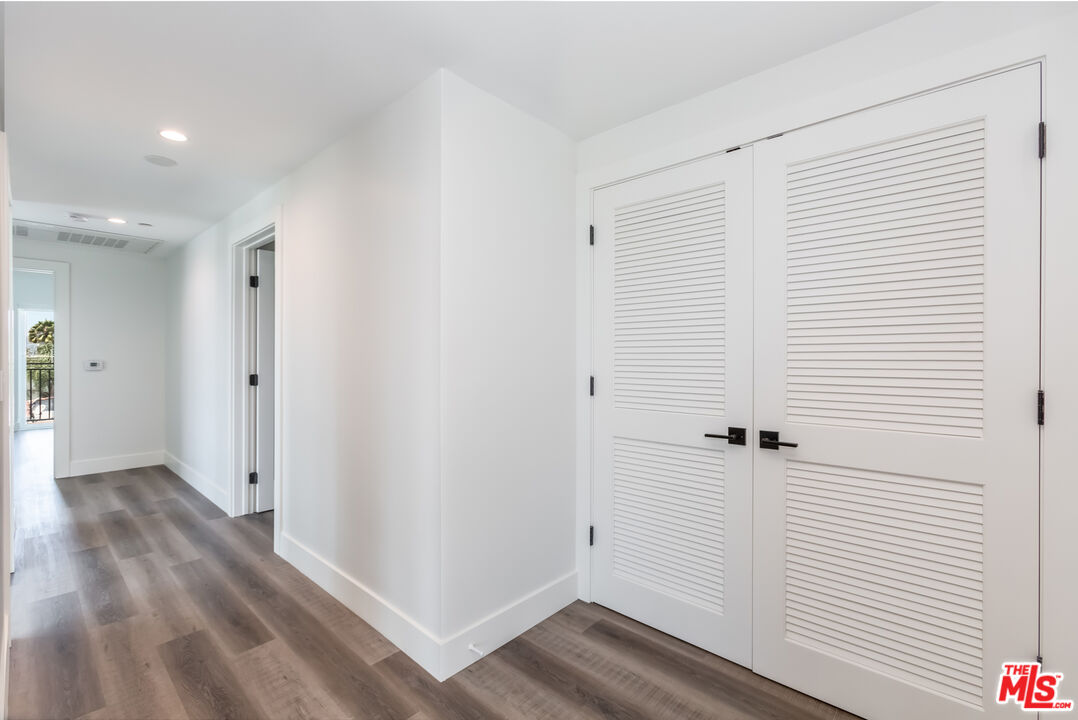 857 North Hayworth Avenue, Unit 403 Los Angeles, CA 90046 - Photo 30 of 52 a view of a hallway with wooden floor