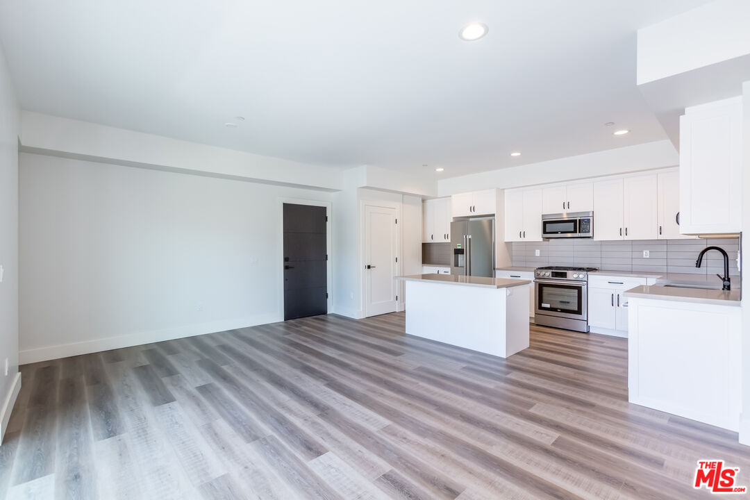 857 North Hayworth Avenue, Unit 403 Los Angeles, CA 90046 - Photo 32 of 52 a view of kitchen with cabinets appliances and wooden floor