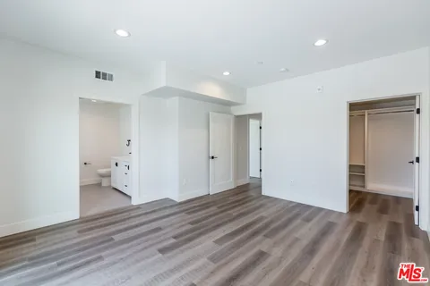 an empty room with wooden floor and a window