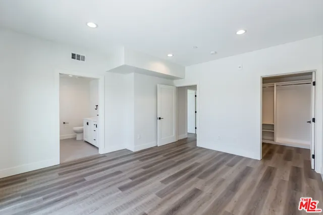 an empty room with wooden floor and a window