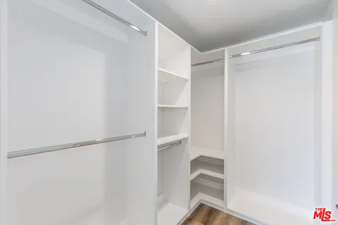 a view of hallway with wooden floor