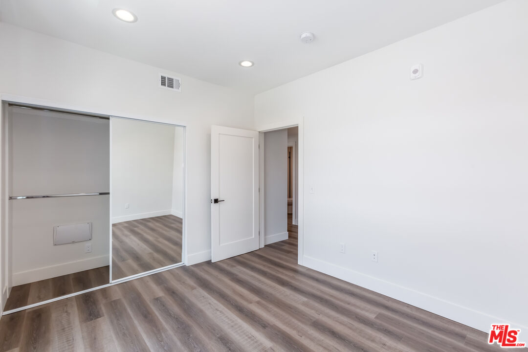 857 North Hayworth Avenue, Unit 403 Los Angeles, CA 90046 - Photo 40 of 52 a view of hallway with wooden floor