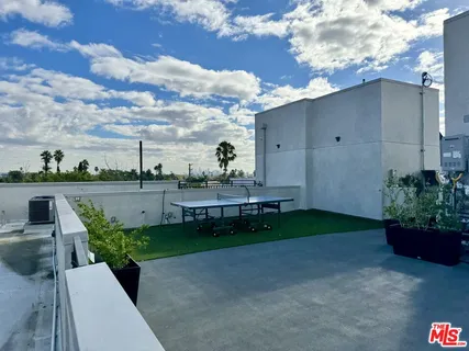 a view of a city with lawn chairs and a yard