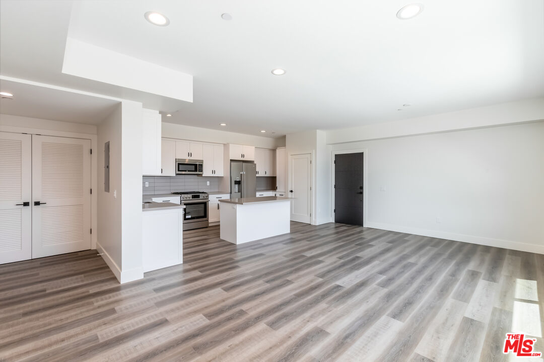 857 North Hayworth Avenue, Unit 403 Los Angeles, CA 90046 - Photo 5 of 52 a view of kitchen with wooden floor