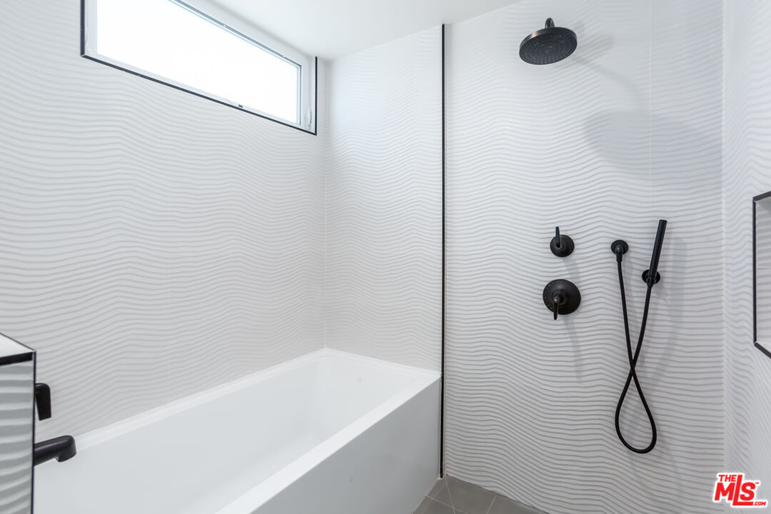 857 North Hayworth Avenue, Unit 403 Los Angeles, CA 90046 - Photo 10 of 52 a bathroom with a shower and a bathtub