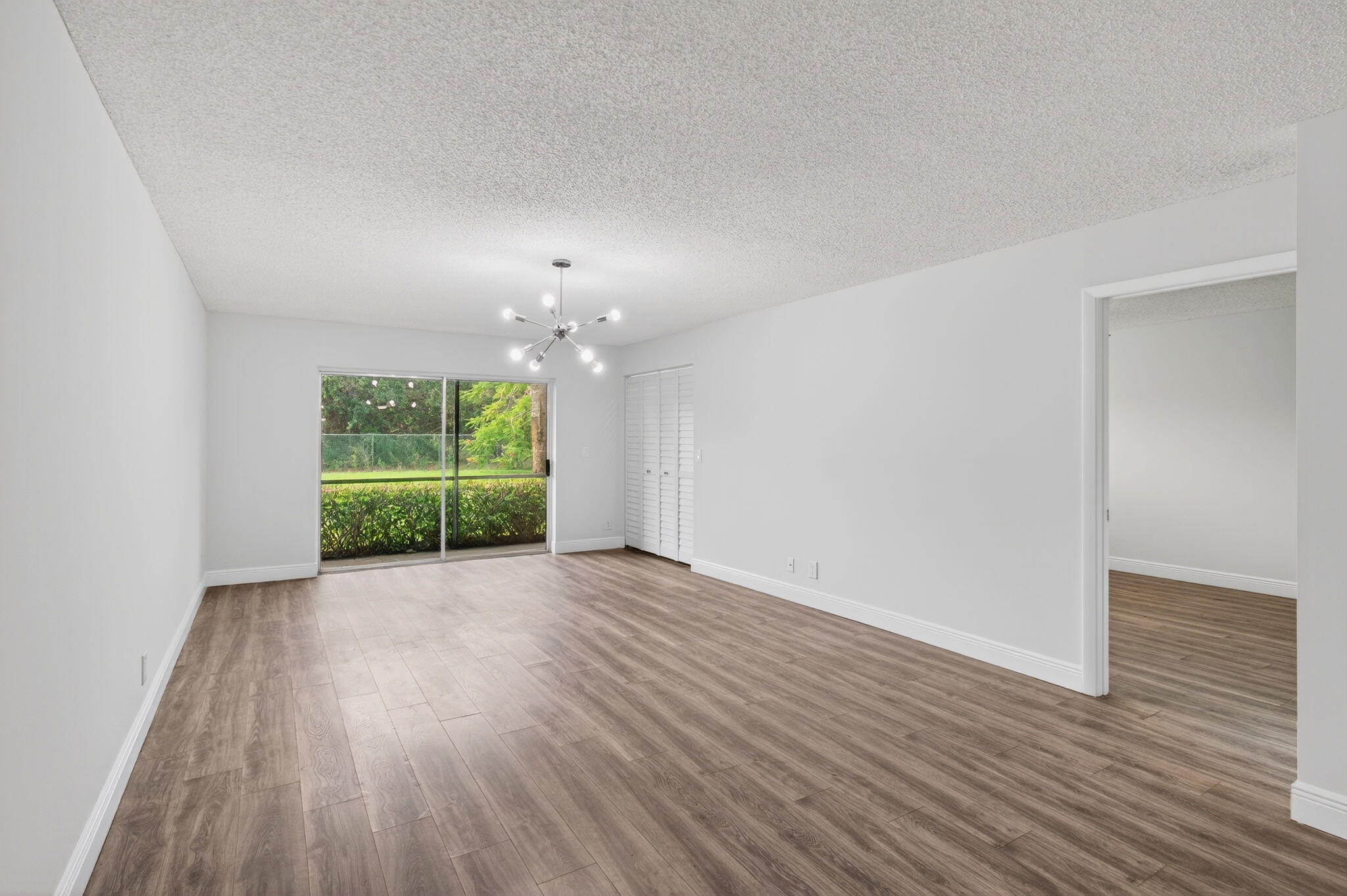 2975 Southwest 22nd Avenue, Unit 1070 Delray Beach, FL 33445 - Photo 11 of 60 a view of an empty room with a window and wooden floor