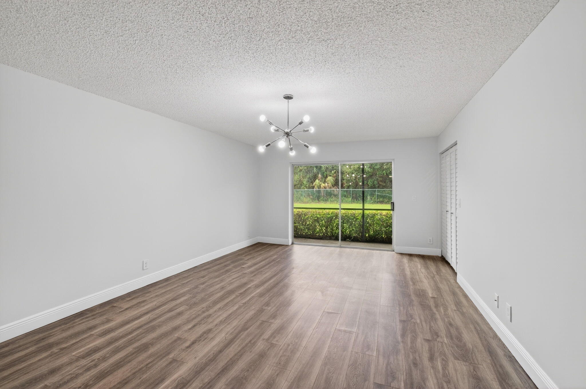 2975 Southwest 22nd Avenue, Unit 1070 Delray Beach, FL 33445 - Photo 12 of 60 a view of an empty room with a window and wooden floor