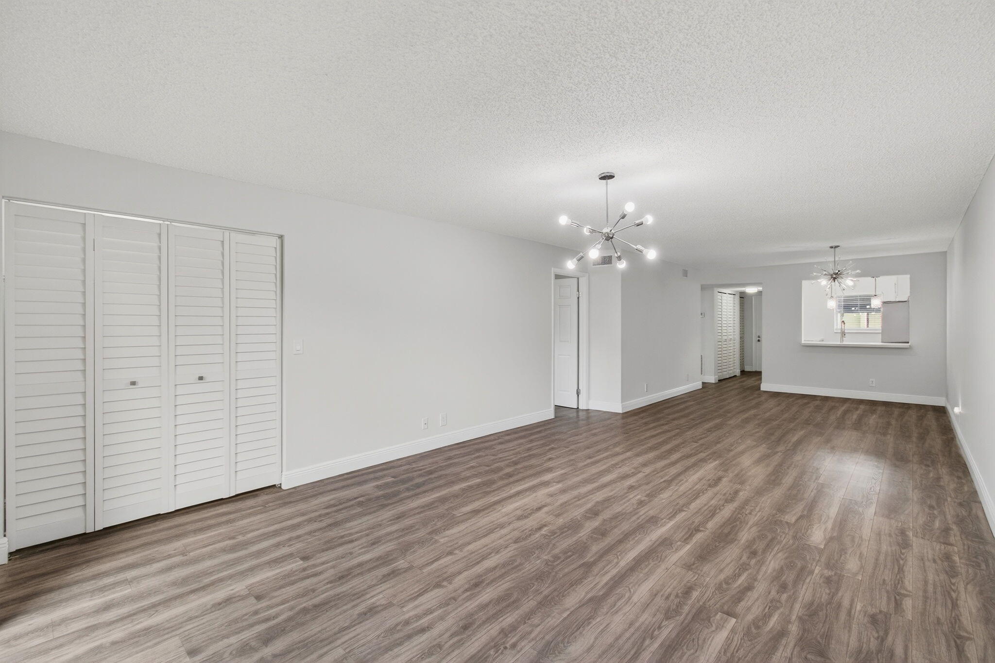 2975 Southwest 22nd Avenue, Unit 1070 Delray Beach, FL 33445 - Photo 14 of 60 a view of an empty room with wooden floor and a window