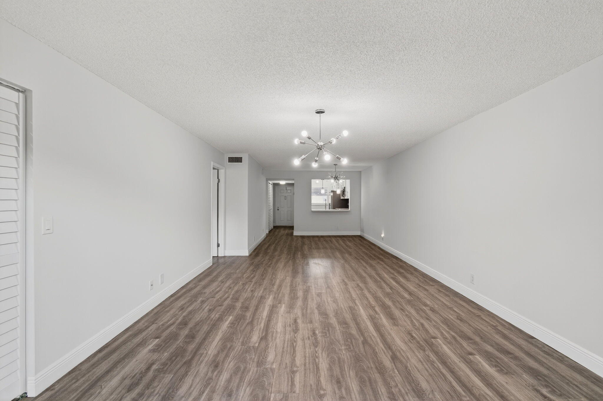 2975 Southwest 22nd Avenue, Unit 1070 Delray Beach, FL 33445 - Photo 15 of 60 a view of a room with wooden floor and large window