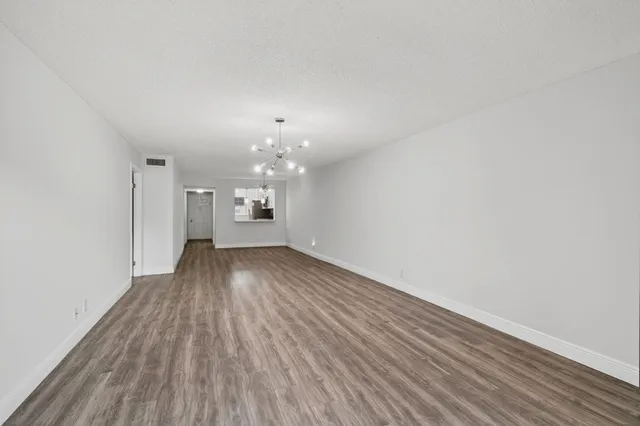 a view of wooden floor and windows in a room