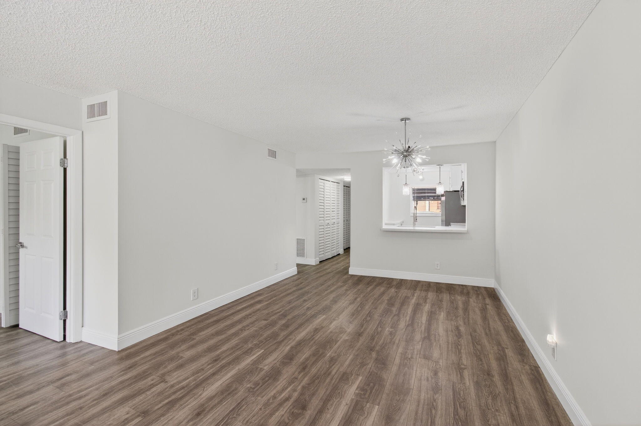 2975 Southwest 22nd Avenue, Unit 1070 Delray Beach, FL 33445 - Photo 19 of 60 an empty room with wooden floor cabinet and windows