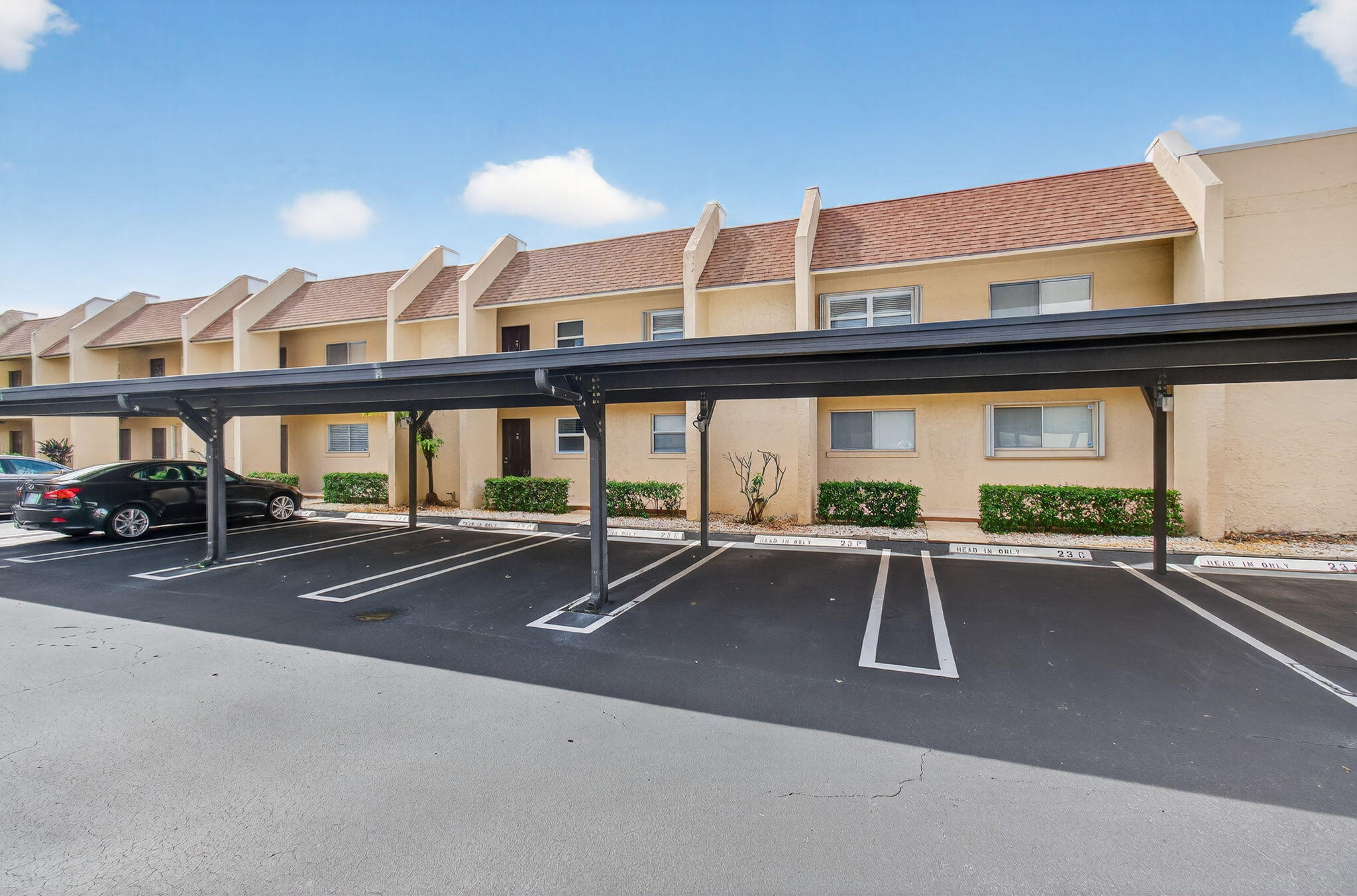 2975 Southwest 22nd Avenue, Unit 1070 Delray Beach, FL 33445 - Photo 2 of 60 a view of a patio with a table and chairs under an umbrellas