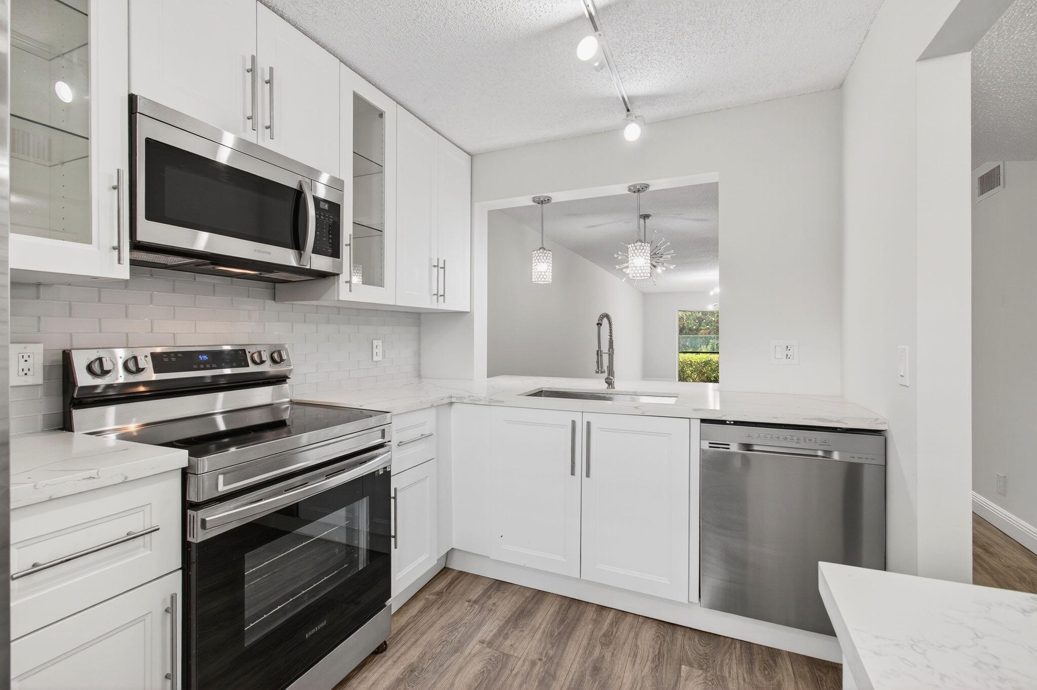 2975 Southwest 22nd Avenue, Unit 1070 Delray Beach, FL 33445 - Photo 24 of 60 a kitchen with stainless steel appliances a stove microwave and sink
