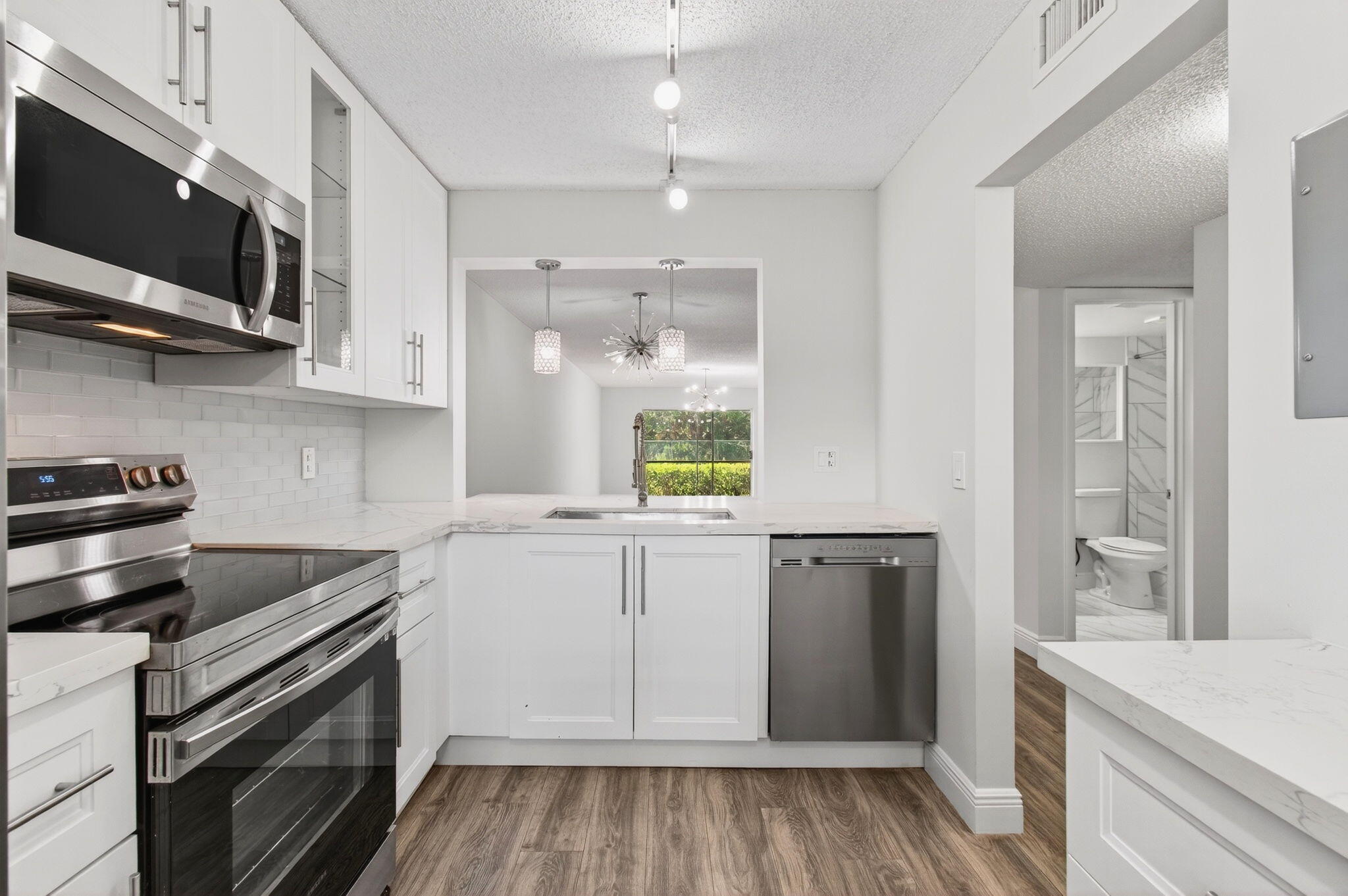 2975 Southwest 22nd Avenue, Unit 1070 Delray Beach, FL 33445 - Photo 25 of 60 a kitchen with a sink stove and microwave