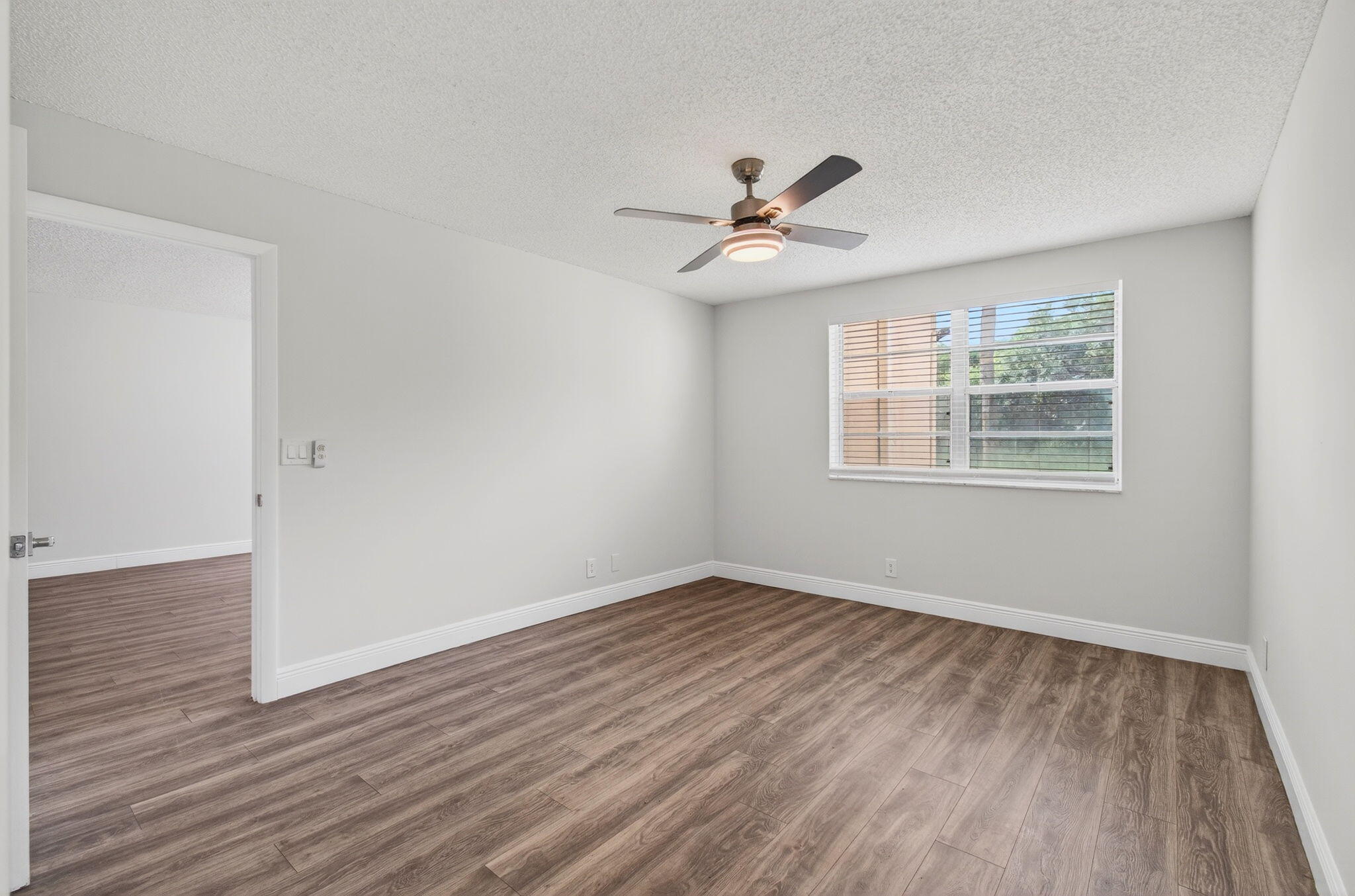 2975 Southwest 22nd Avenue, Unit 1070 Delray Beach, FL 33445 - Photo 28 of 60 a view of empty room with wooden floor and fan