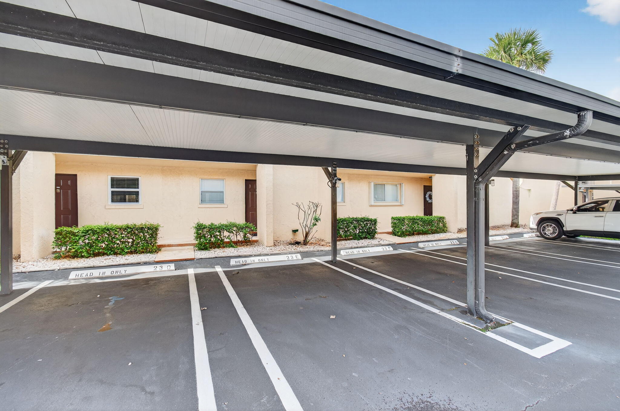 2975 Southwest 22nd Avenue, Unit 1070 Delray Beach, FL 33445 - Photo 3 of 60 a view of a building with car parked