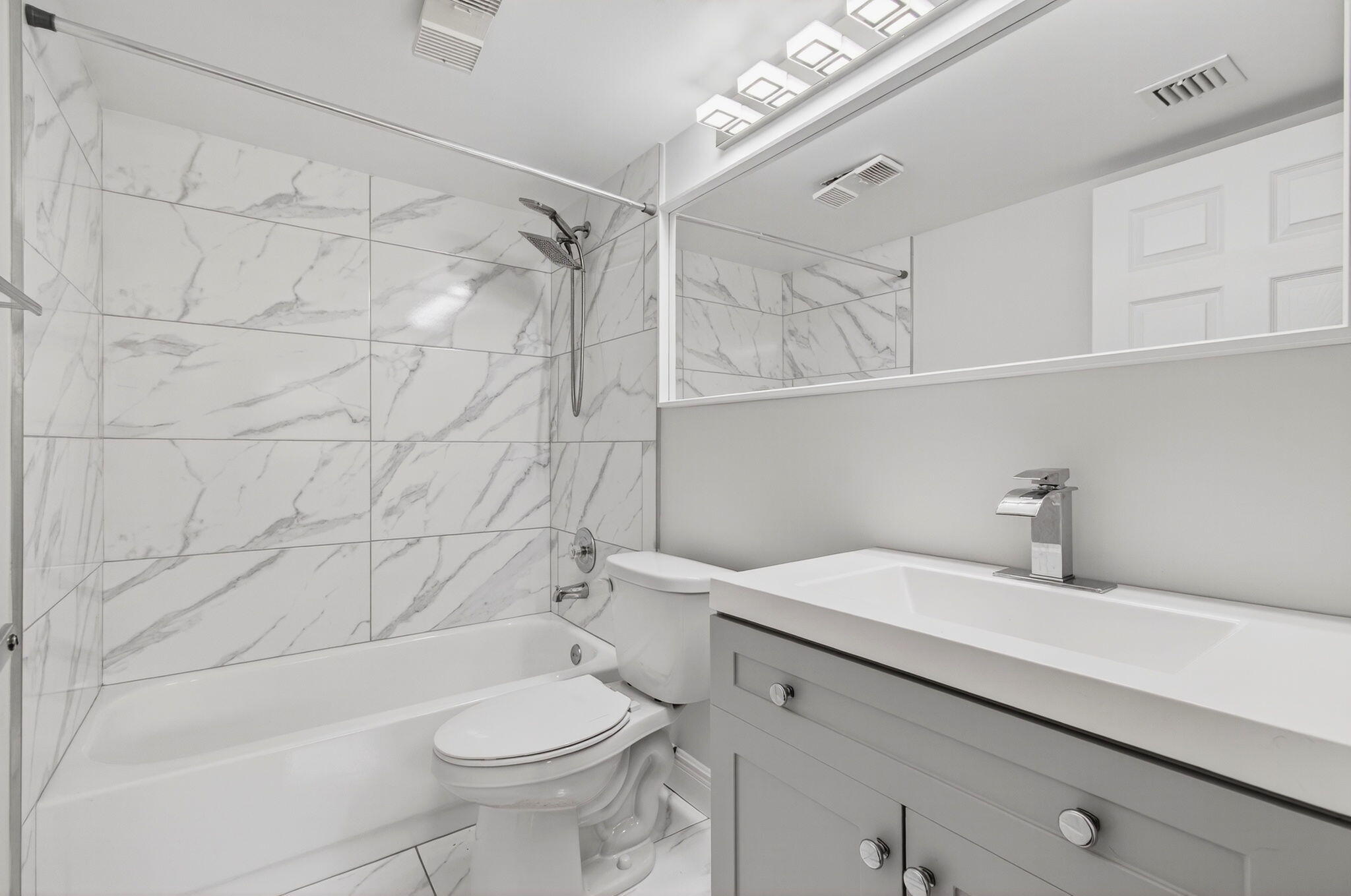 2975 Southwest 22nd Avenue, Unit 1070 Delray Beach, FL 33445 - Photo 33 of 60 a bathroom with a sink a toilet and shower