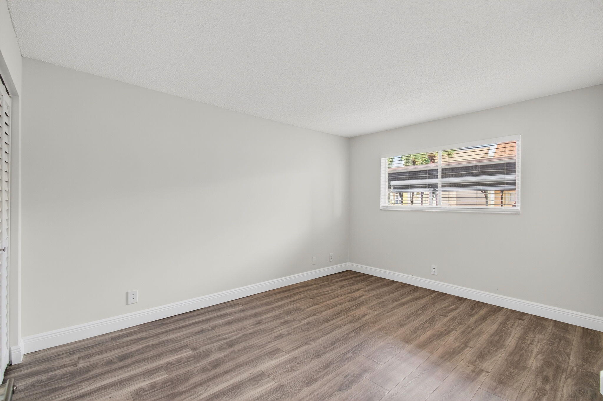 2975 Southwest 22nd Avenue, Unit 1070 Delray Beach, FL 33445 - Photo 36 of 60 a view of a room with wooden floor and window
