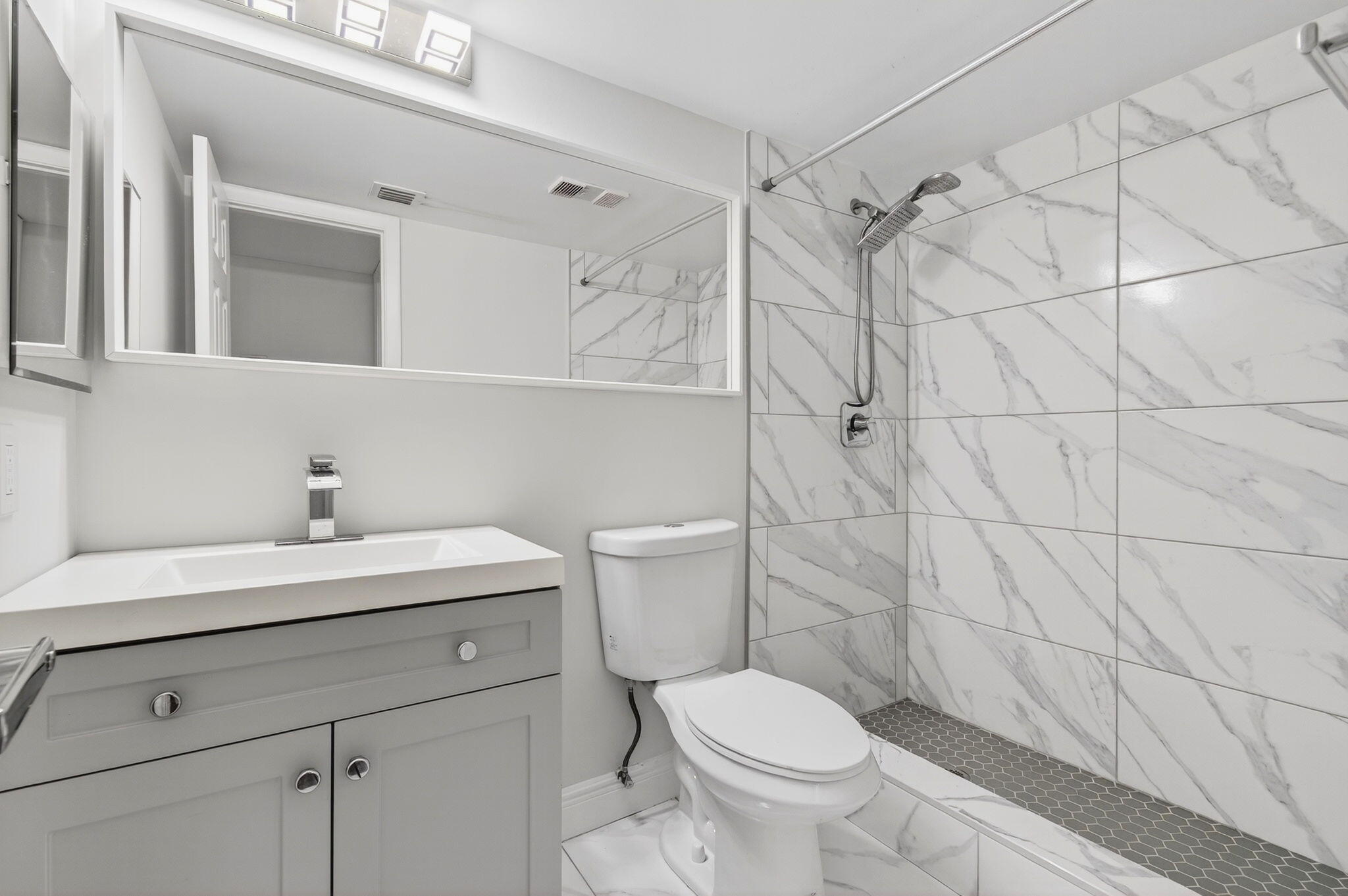 2975 Southwest 22nd Avenue, Unit 1070 Delray Beach, FL 33445 - Photo 41 of 60 a bathroom with a sink a toilet and shower