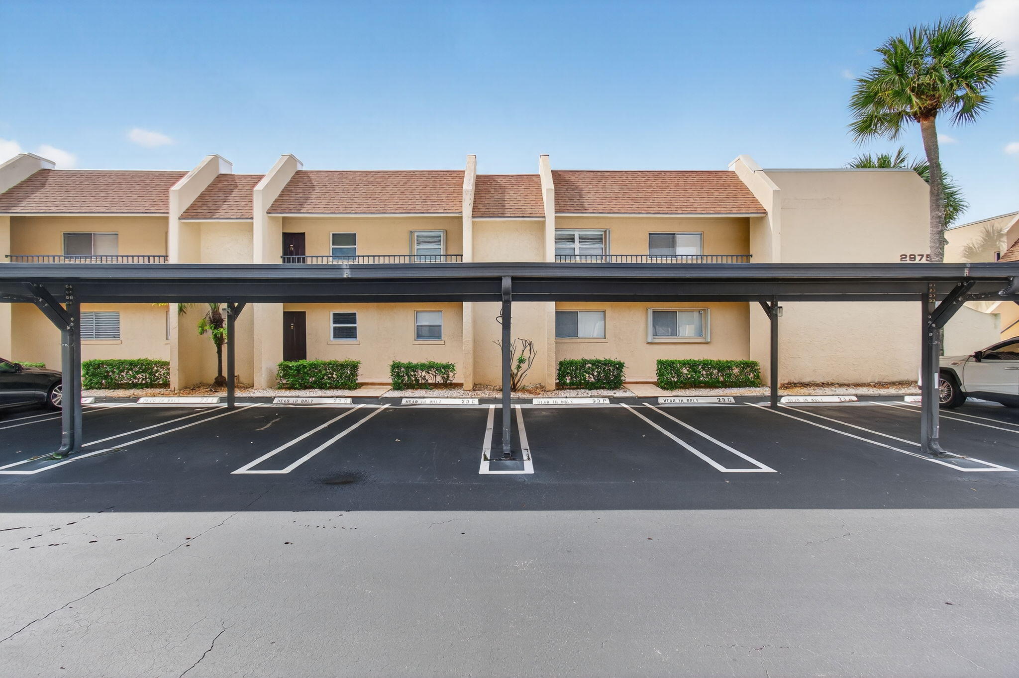 2975 Southwest 22nd Avenue, Unit 1070 Delray Beach, FL 33445 - Photo 50 of 60 a view of pool with a car parked