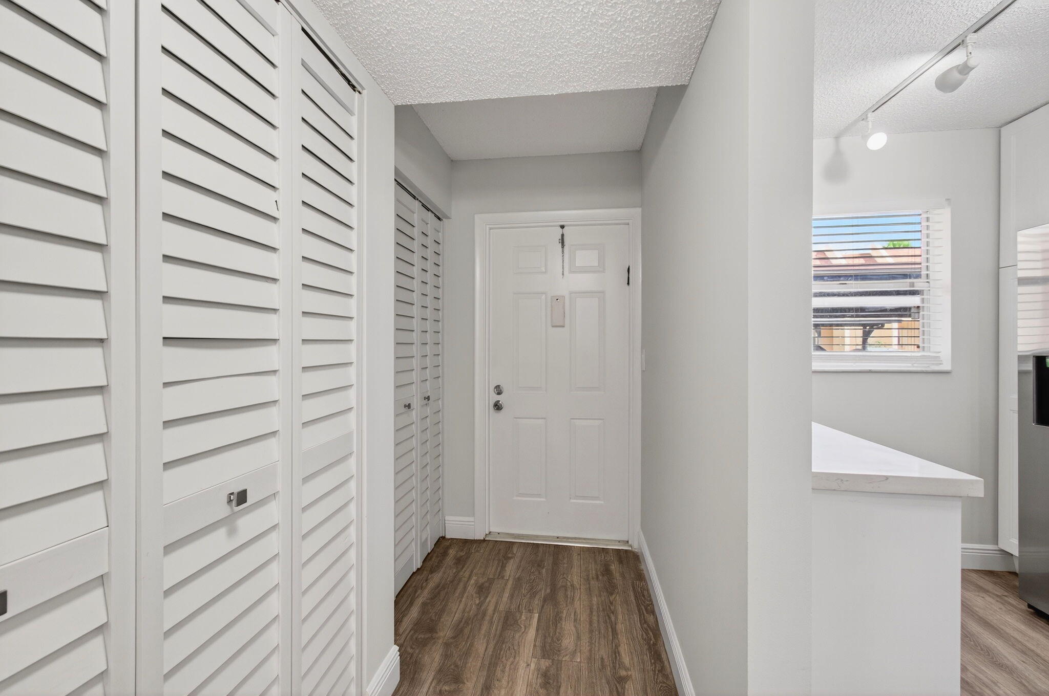 2975 Southwest 22nd Avenue, Unit 1070 Delray Beach, FL 33445 - Photo 5 of 60 a view of a hallway with wooden floor and a bathroom