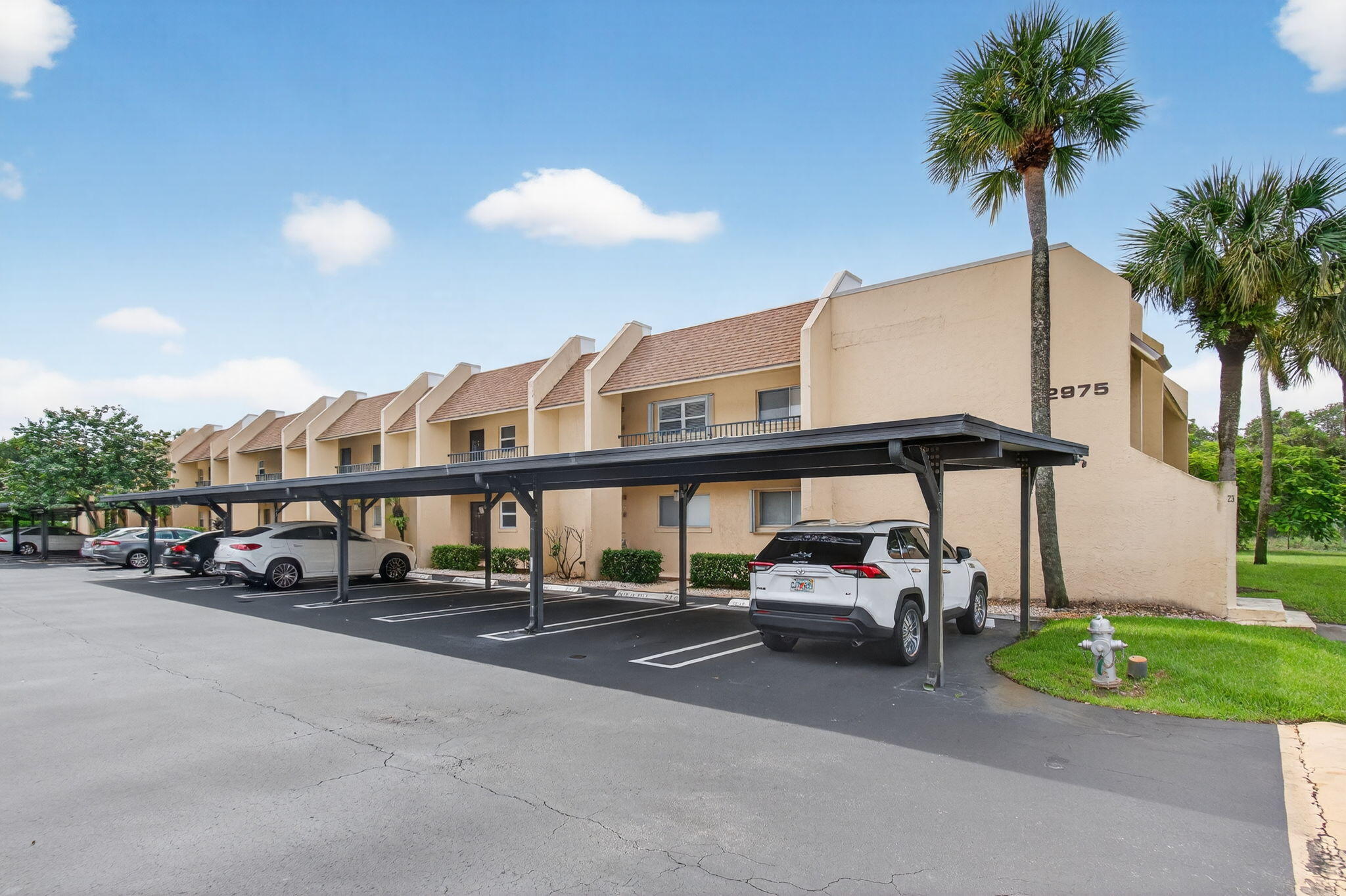 2975 Southwest 22nd Avenue, Unit 1070 Delray Beach, FL 33445 - Photo 56 of 60 a car parked on the side of the road