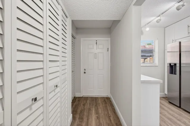 a view of hallway with wooden floor