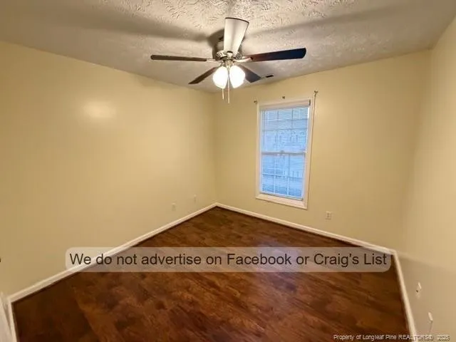 a view of a room with a window and a ceiling fan