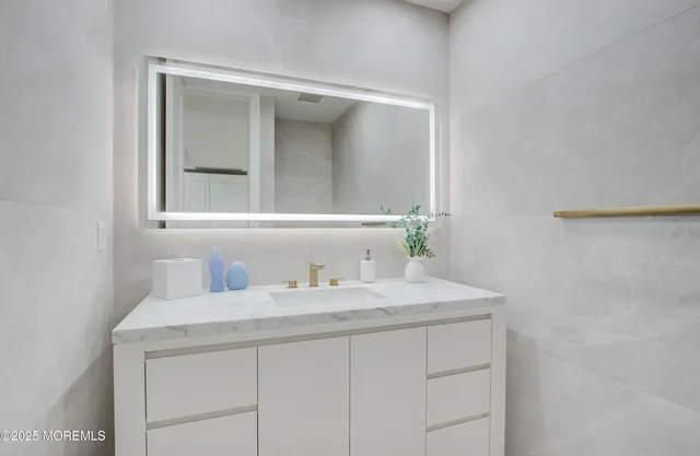 a bathroom with a sink and a mirror