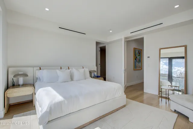 a bedroom with a large bed and a couch