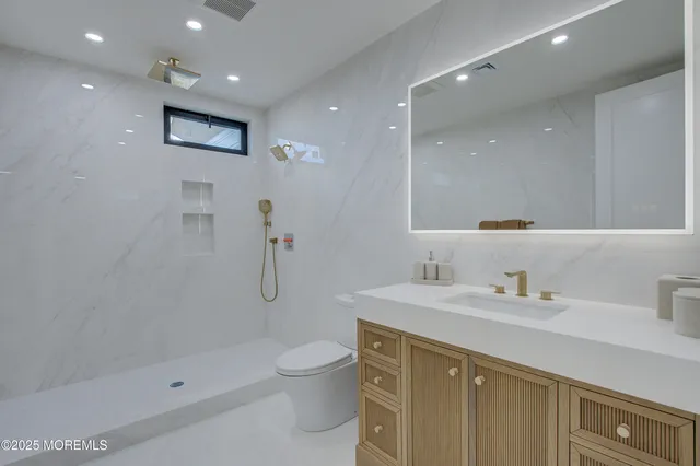 a bathroom with a toilet sink and shower