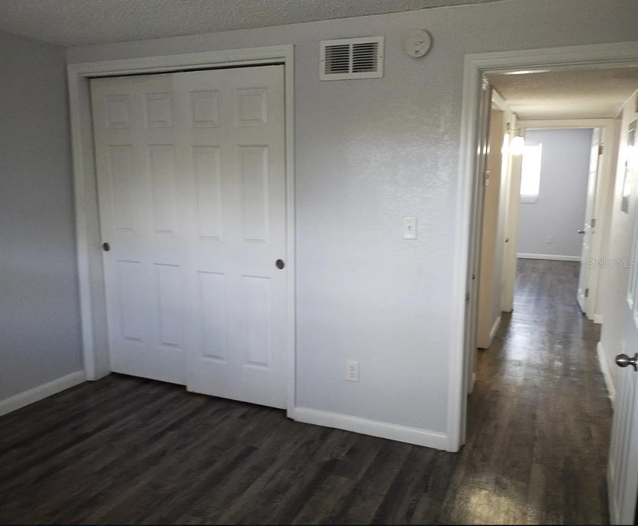 9911 Aquarius Drive, Unit 3 Port Richey, FL 34668 - Photo 11 of 25 a view of a room with wooden floor