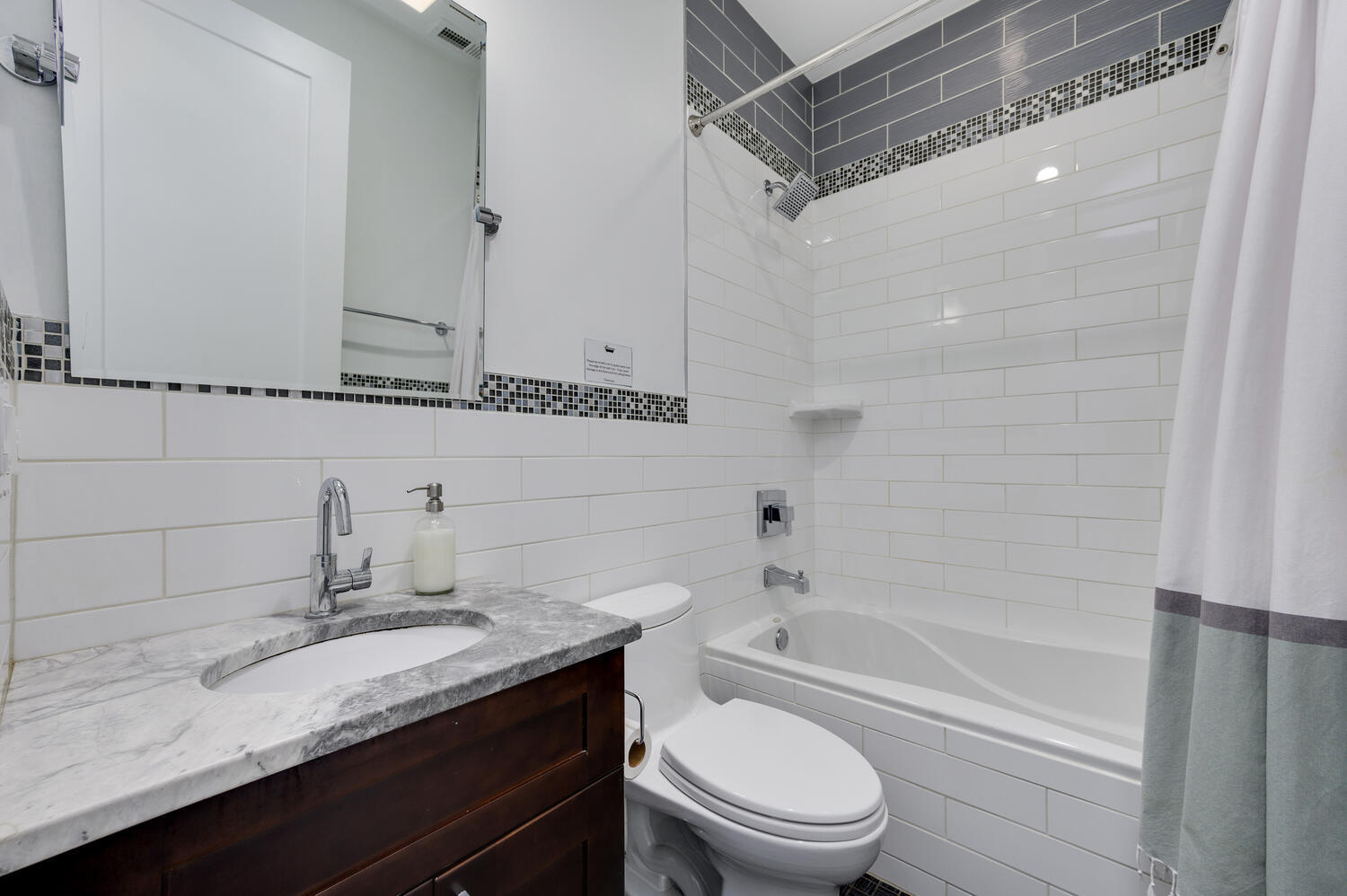 113 West Elm Street Chicago, IL 60610 - Photo 17 of 30 a bathroom with a granite countertop sink a toilet and shower