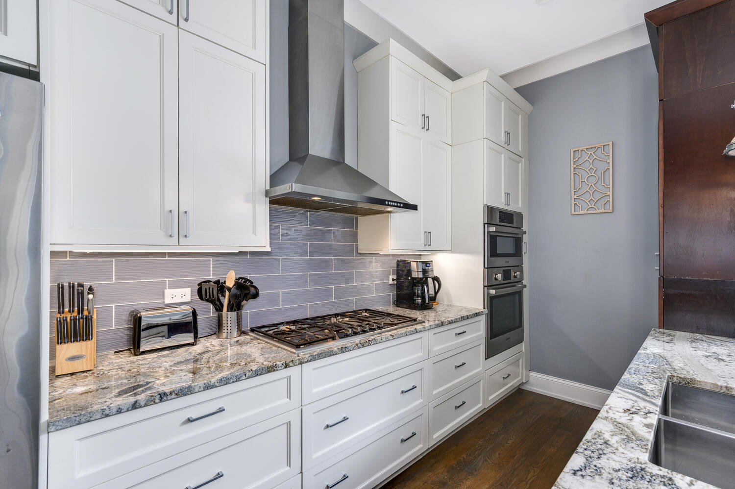 113 West Elm Street Chicago, IL 60610 - Photo 7 of 30 a kitchen with granite countertop white cabinets and white appliances