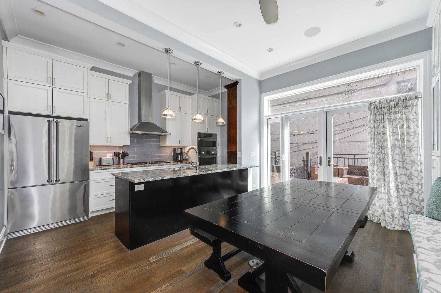 113 West Elm Street Chicago, IL 60610 - Photo 8 of 30 a kitchen with granite countertop a refrigerator a stove a sink a dining table and chairs